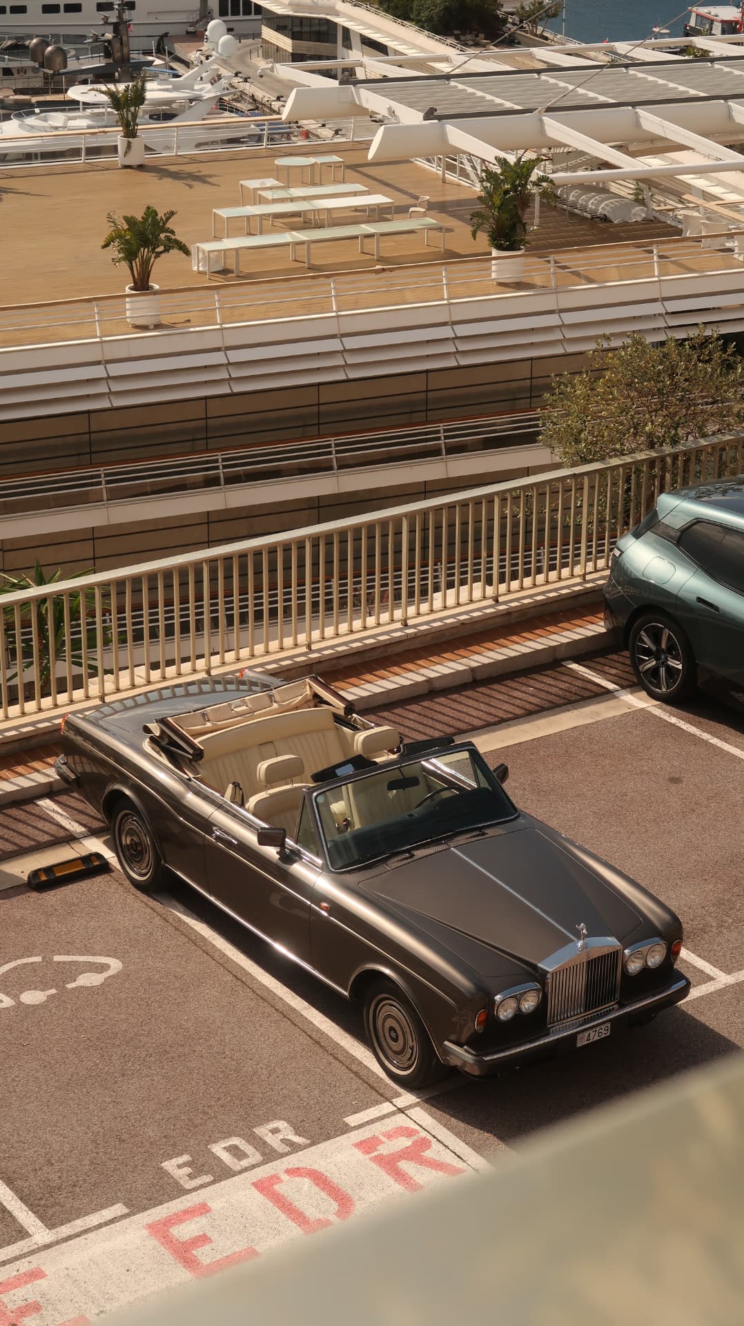 Vintage convertible parked above the Monaco harbour terraces