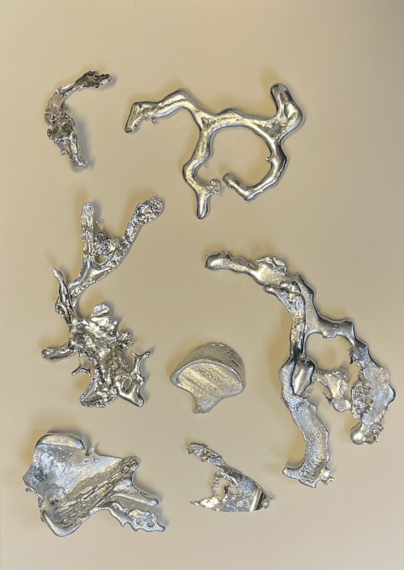 Cast metal fragments arranged on paper