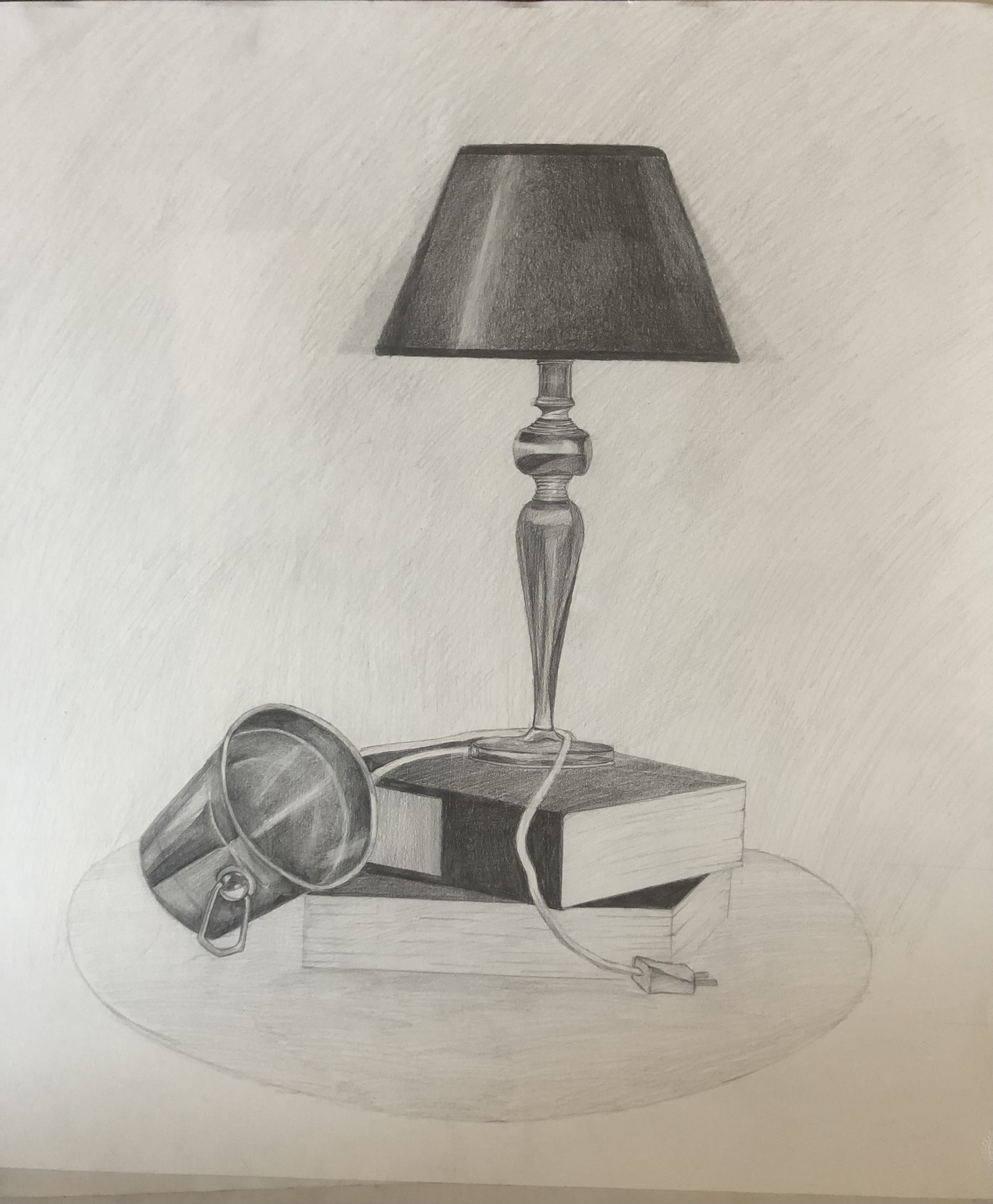 Graphite still life of a table lamp beside a book and a tipped metal scoop