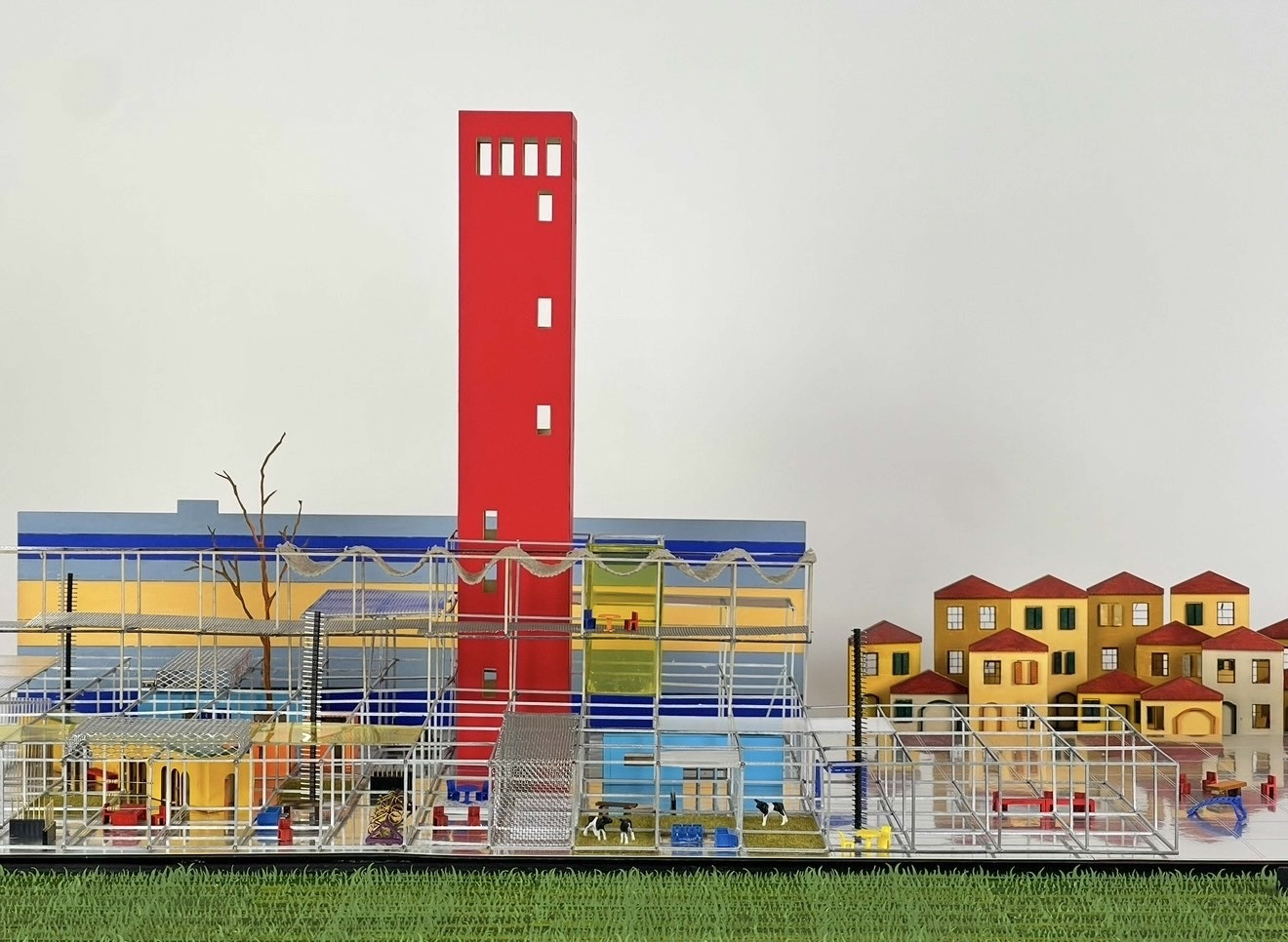 Elevation view of the Metropolitan Circuit model with its red tower, scaffold platform and village beyond