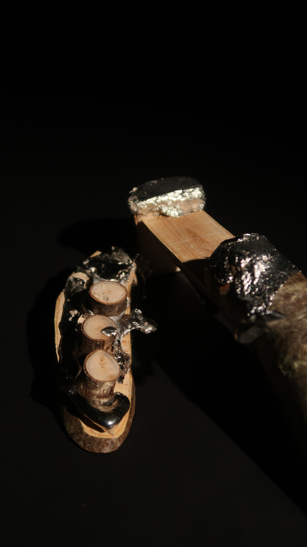 Two model fragments with metal-capped timber and cut log discs